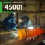Promotional graphic featuring the ISO 45001 Health and Safety Management badge overlaid on a blurred image of workers inside a confined space with ventilation equipment, featuring the CanQualify logo.